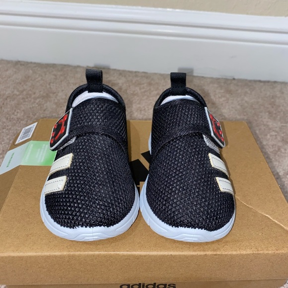 Black pair of strap on Velcro sneakers. - Picture 1 of 3